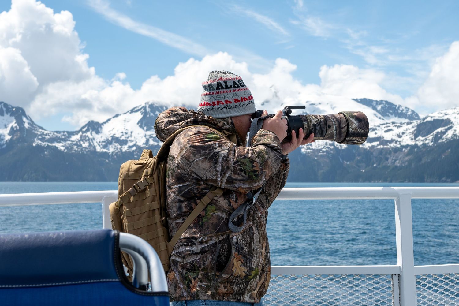 Scenic view of snow-capped mountains and water from a boat or cruise ship perspective.