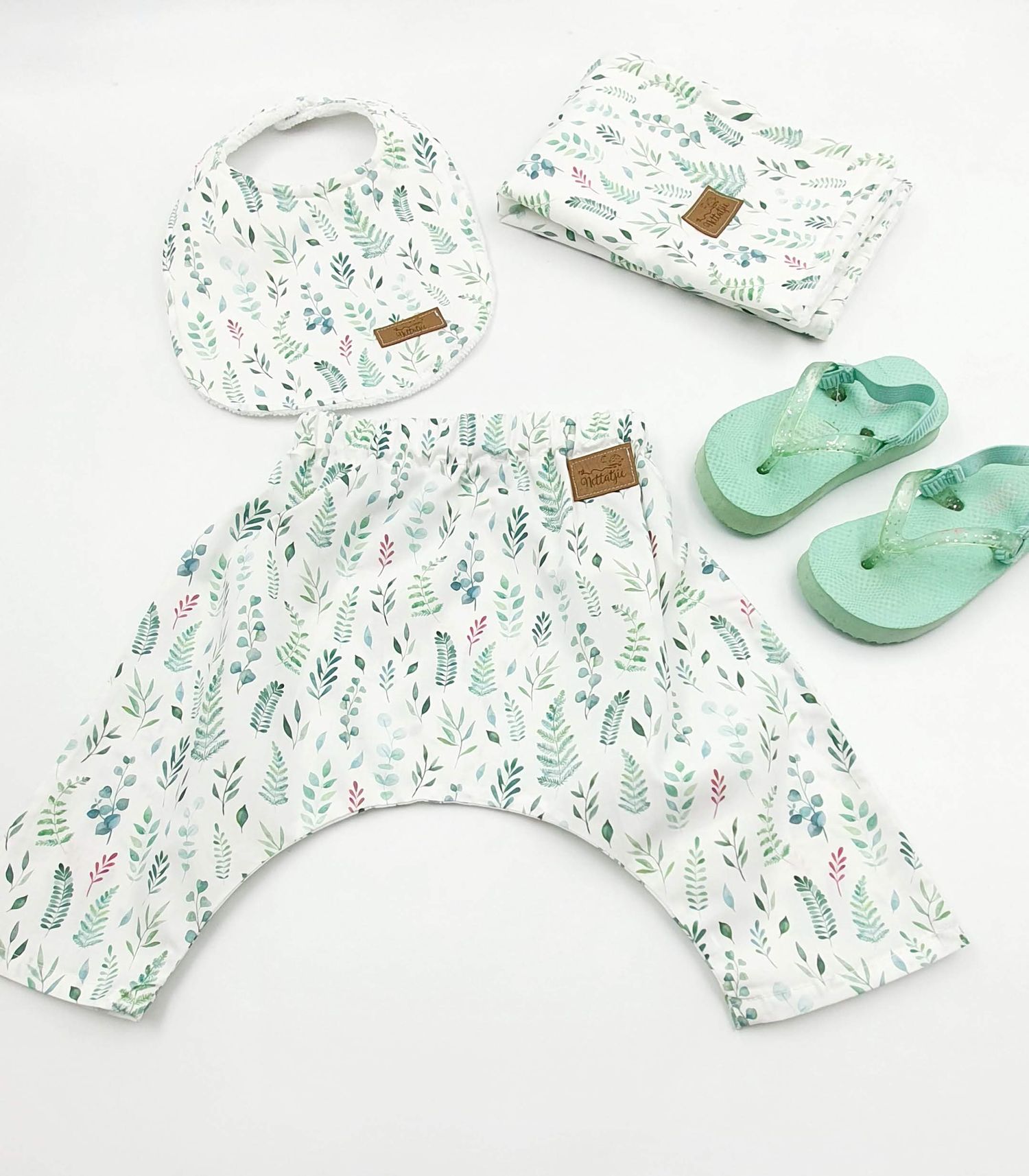 Mint green floral print baby outfit set with matching shoes and bib.