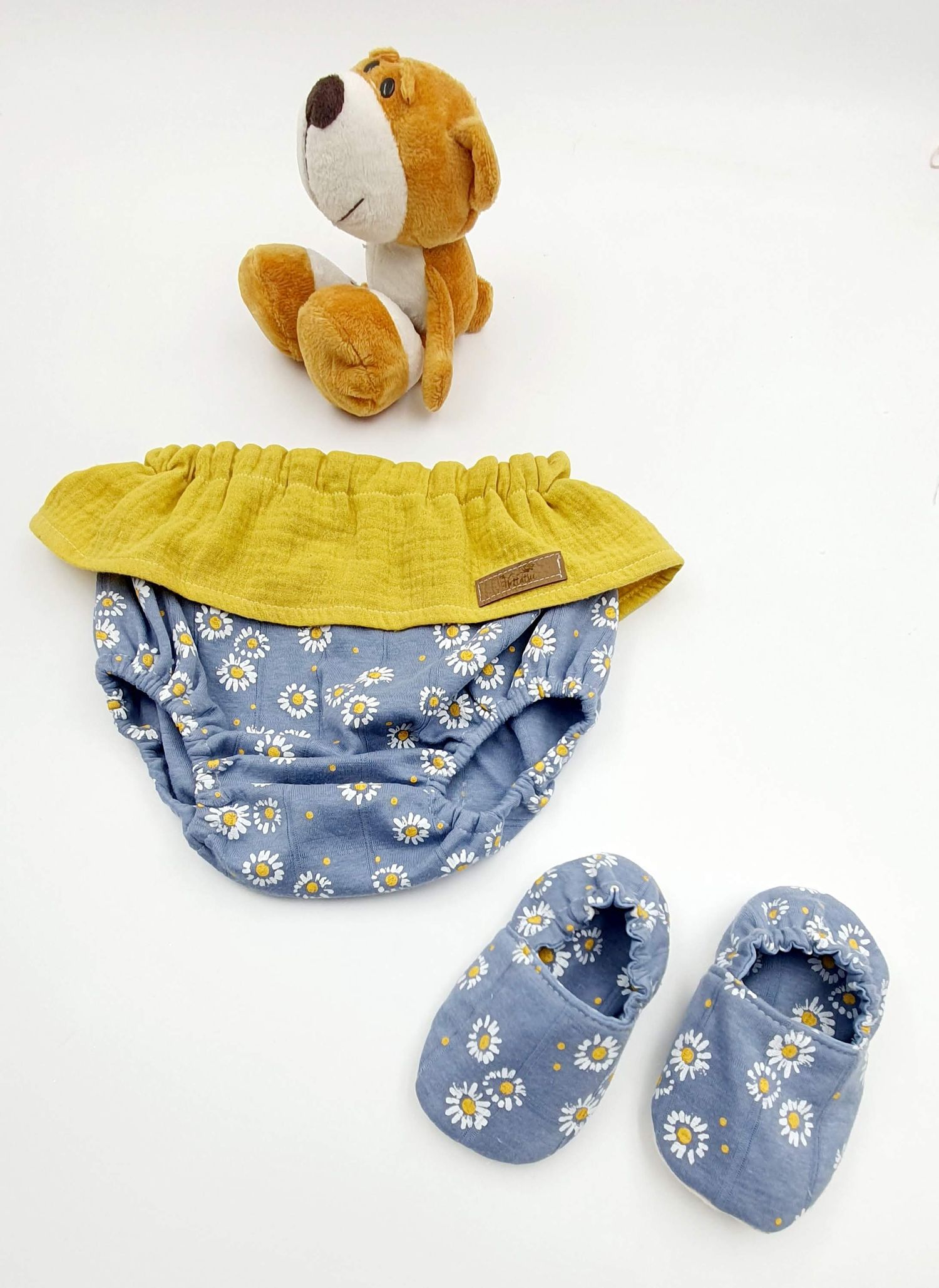 Plush puppy toy with yellow and blue floral print baby bloomers and matching shoes.