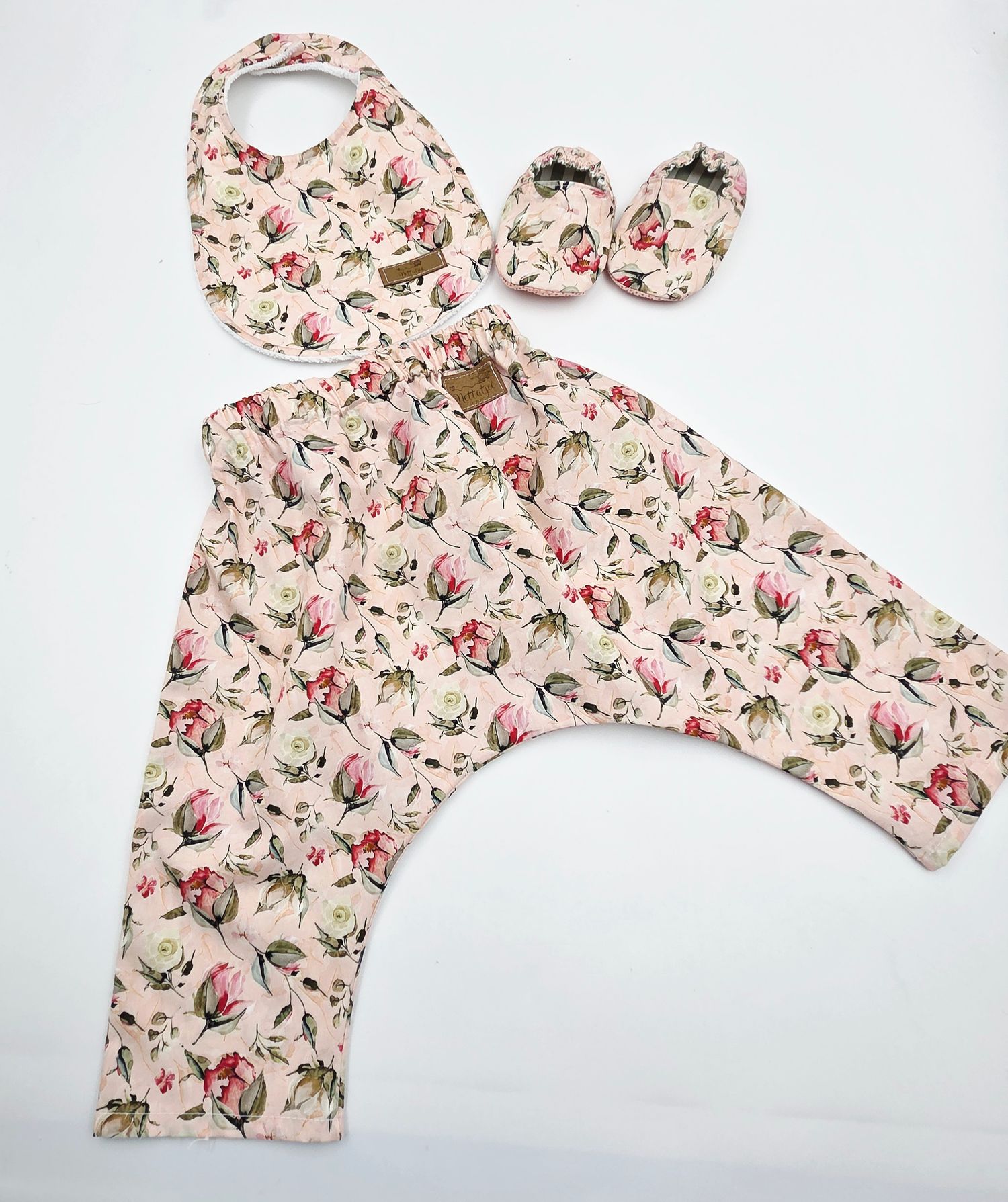 Vintage floral print baby top with ruffled details shown in multiple angles.