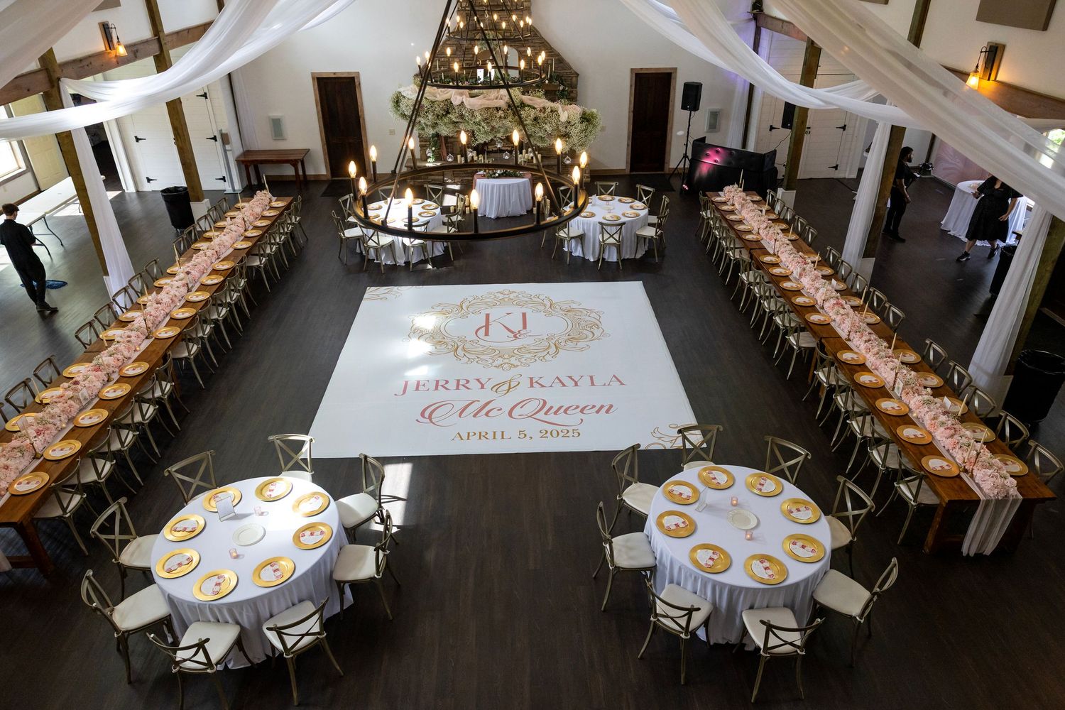 Elegant wedding reception venue with long banquet tables, round guest tables, and a personalized dance floor monogram for Jerry and Kayla.