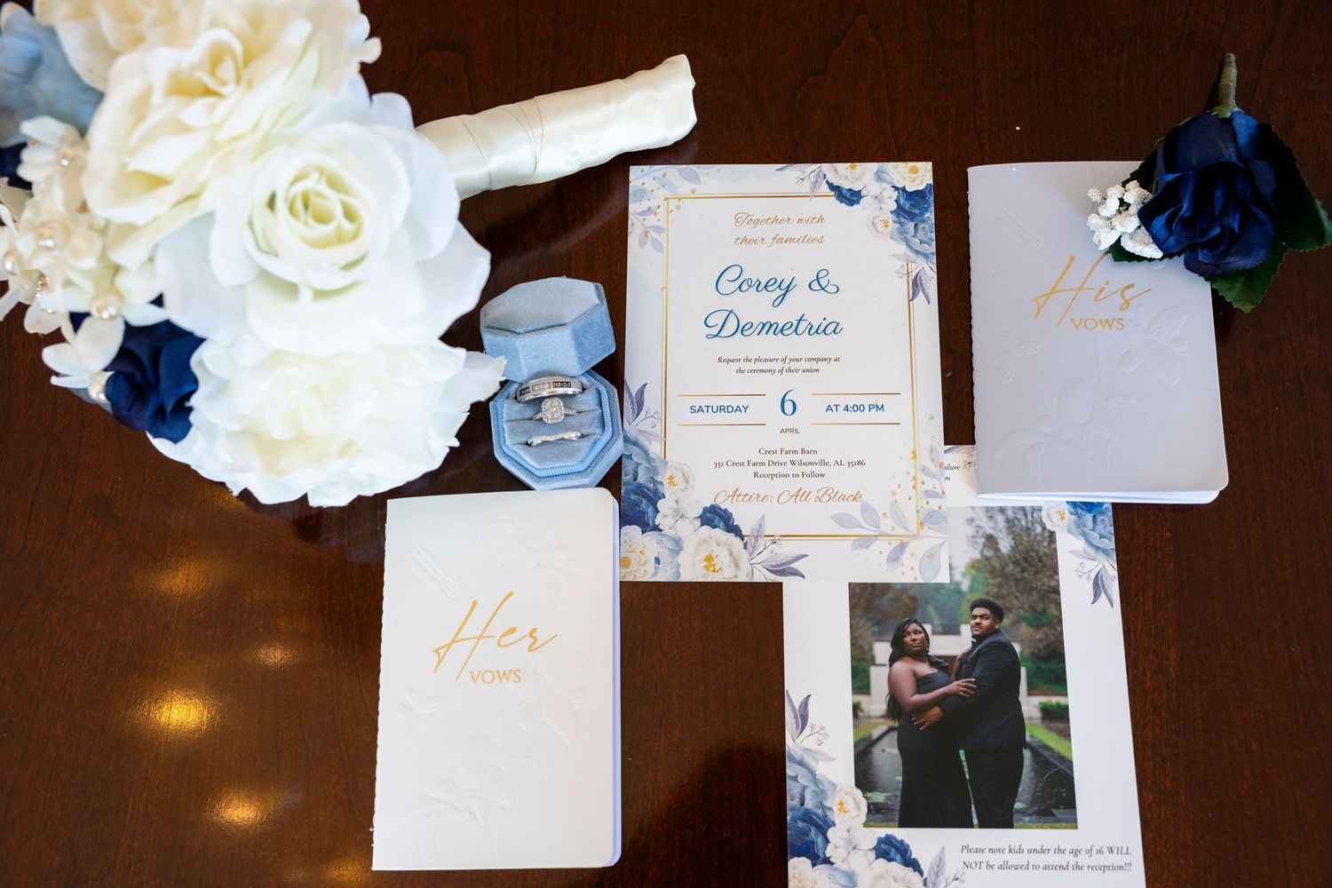 Wedding invitation suite with white roses, navy accents, and golden details.