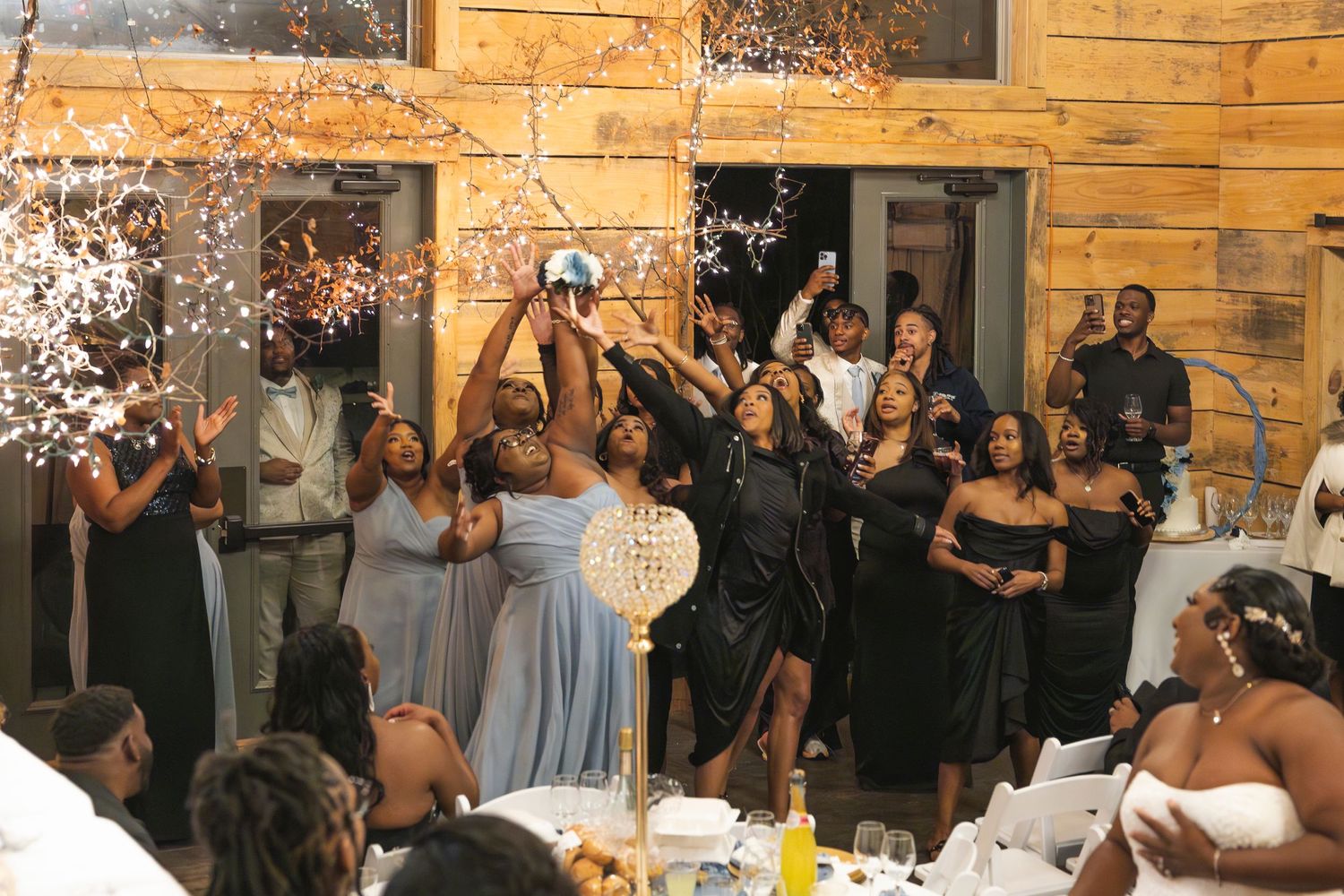 Wedding reception moment with guests celebrating and throwing confetti.