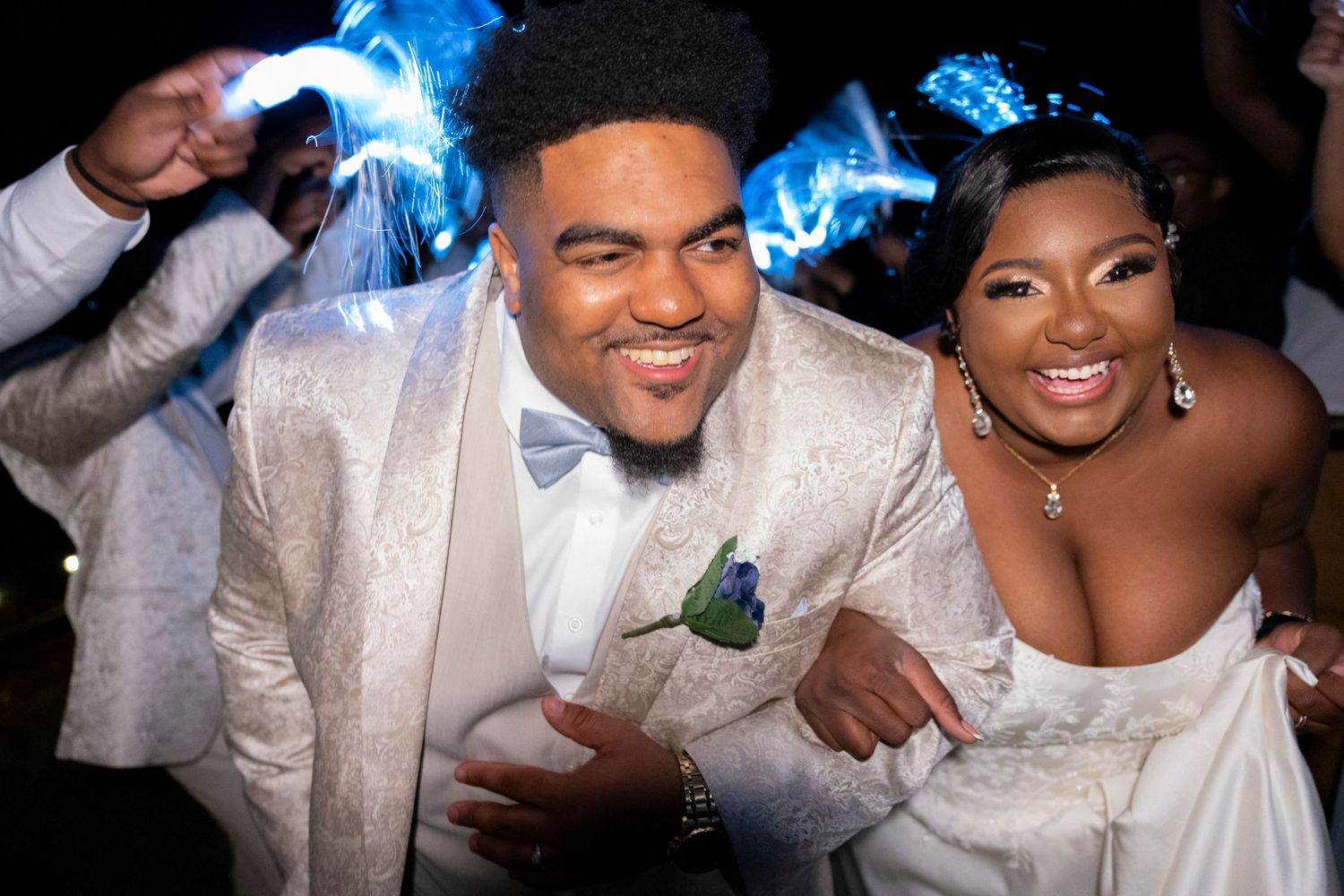 Wedding reception celebration with sparklers creating blue light trails.