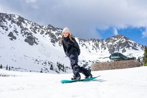 A sequence of snowboarding action shots showing tricks and jumps in snowy mountain terrain.