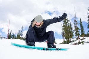 A sequence of five snowboarding jump photos showing aerial tricks and spins against a blue winter mountain sky.