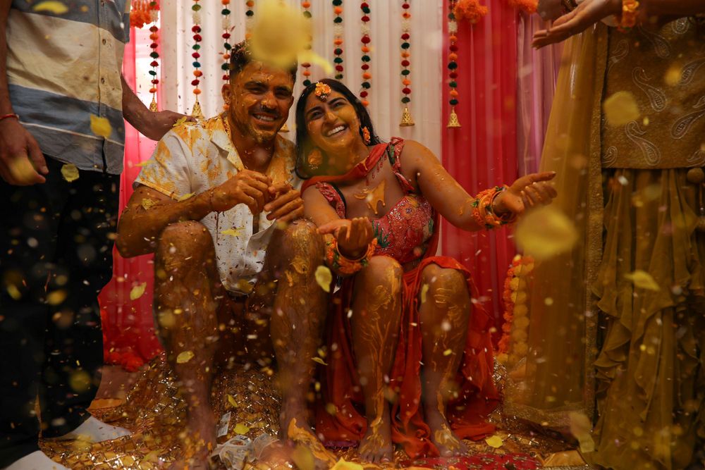 Joyful celebration with confetti at an Indian wedding ceremony.