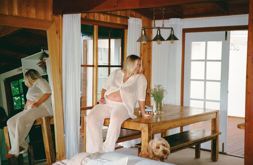 Casual lifestyle photo in rustic interior with dog resting near wooden table.
