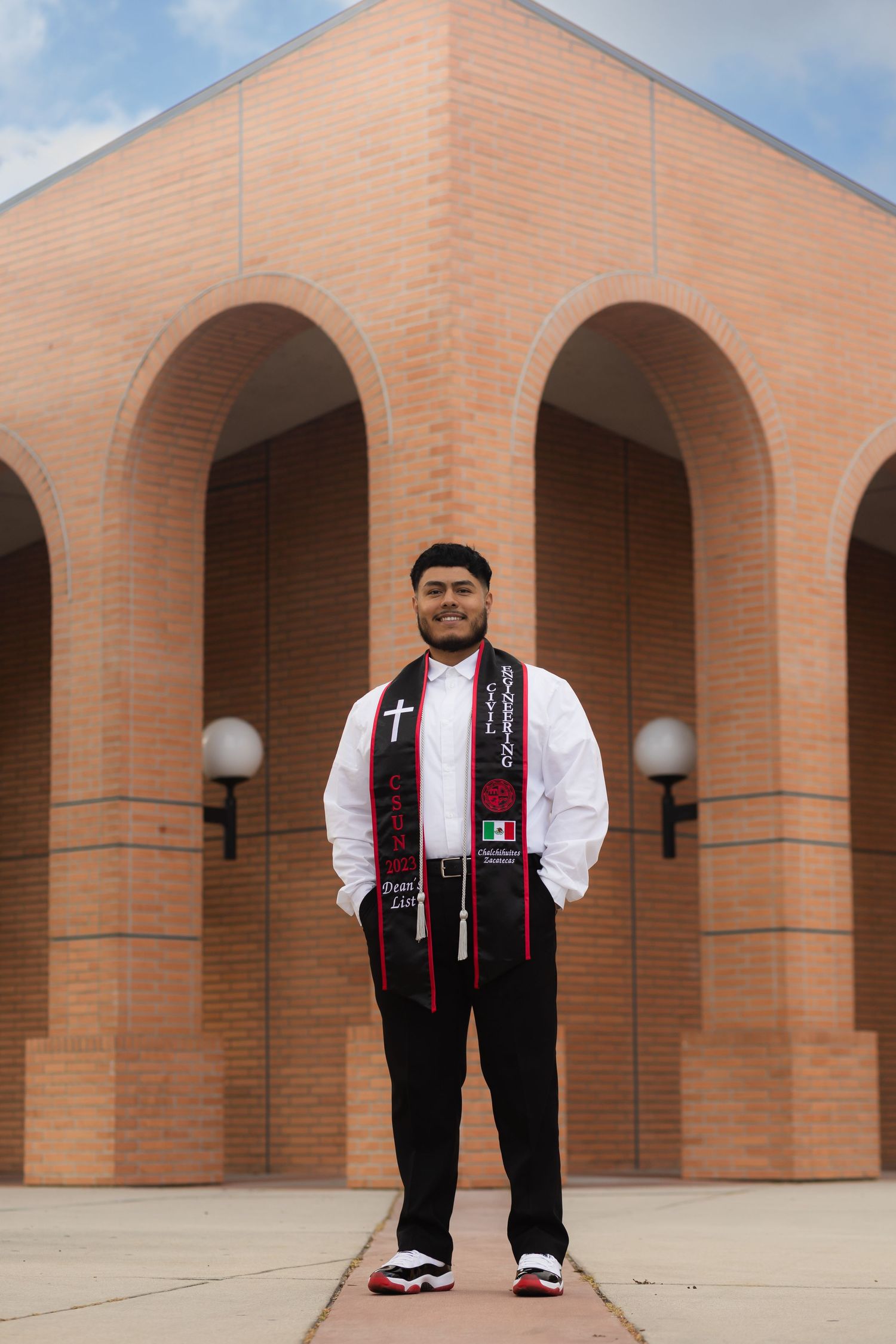 Graduation photoshoot shot at CSUN, California State University of Northridge. Male graduate photographed with style and intent.