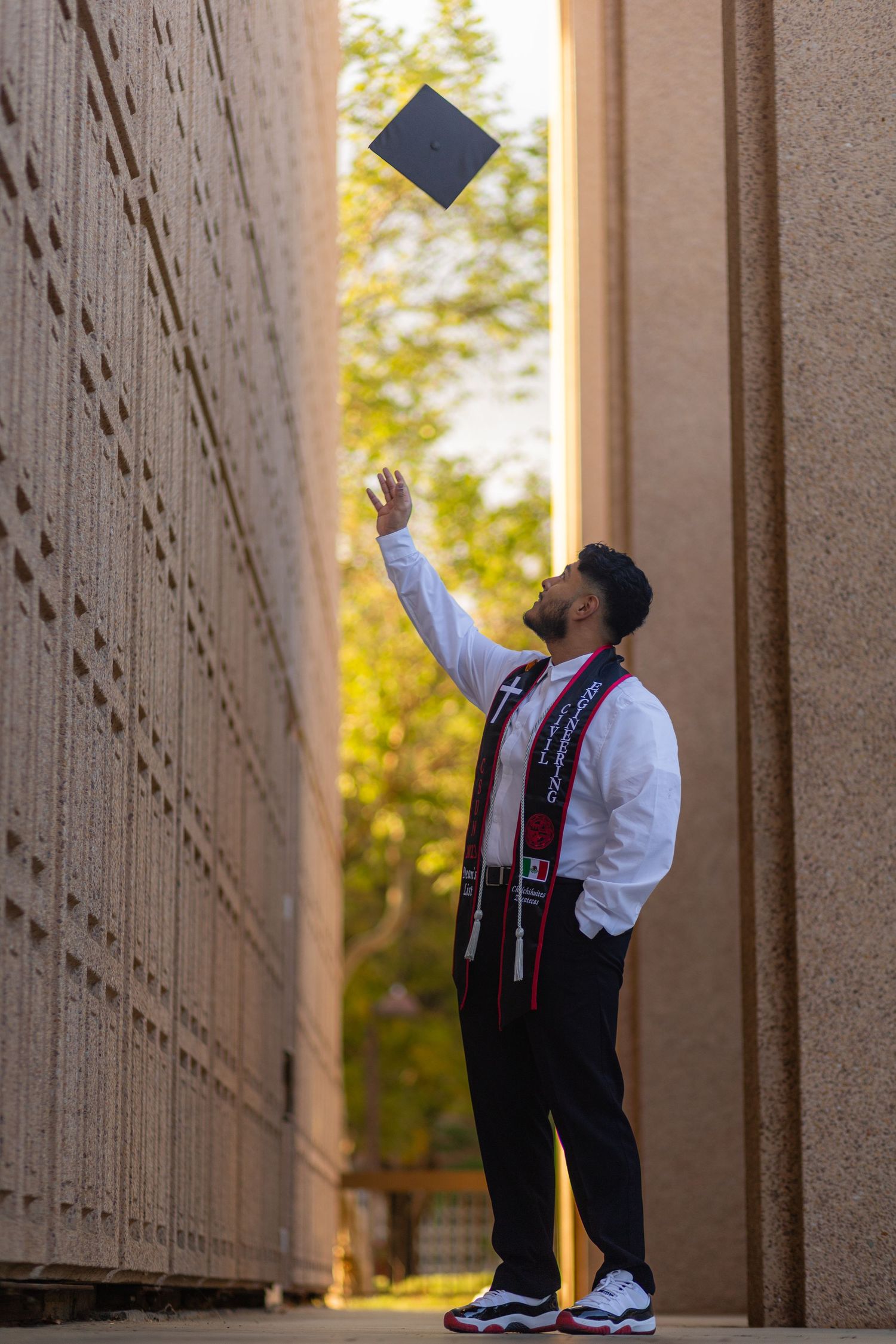Graduation photoshoot shot at CSUN, California State University of Northridge. Male graduate photographed with style and intent.