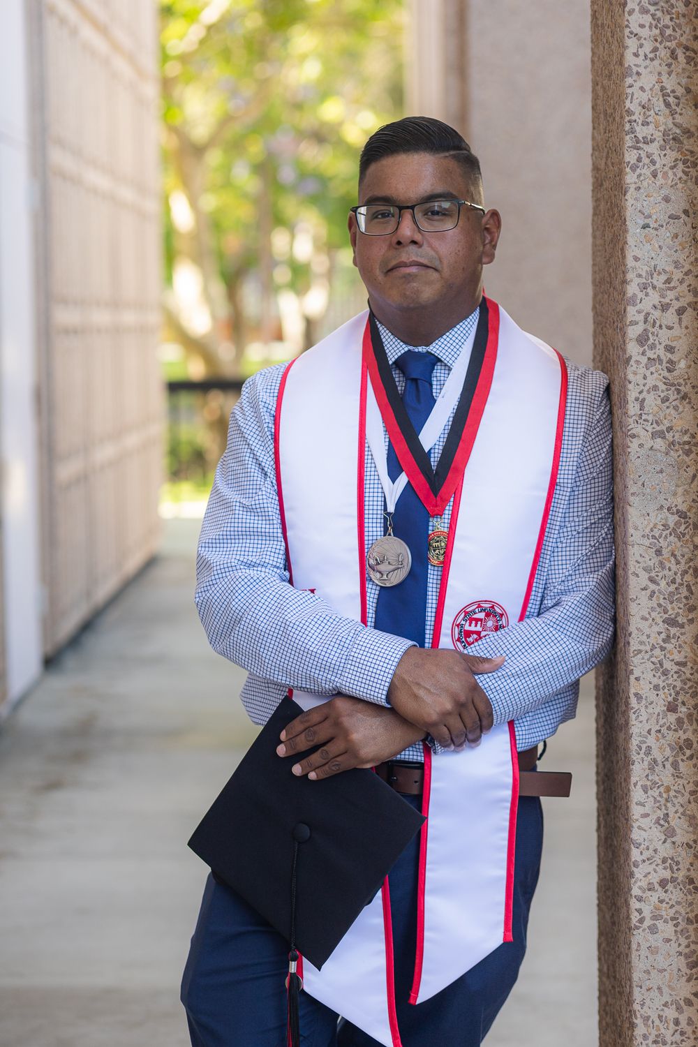 Graduation photoshoot shot at CSUN, California State University of Northridge. Male graduate photographed with style and intent.