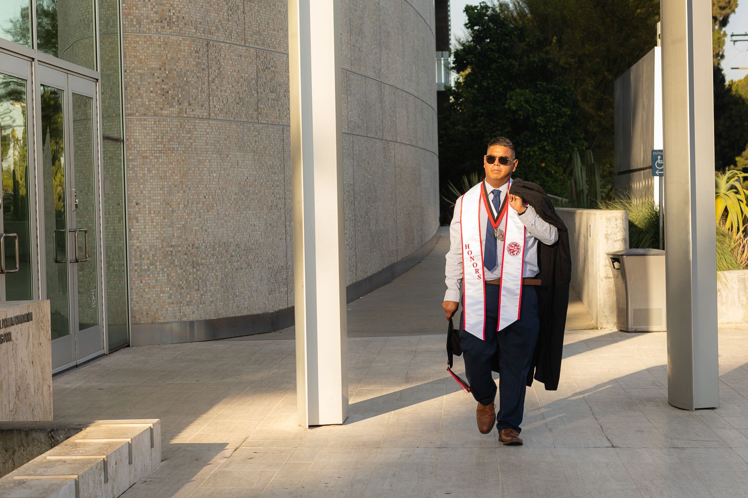 Graduation photoshoot shot at CSUN, California State University of Northridge. Male graduate photographed with style and intent.