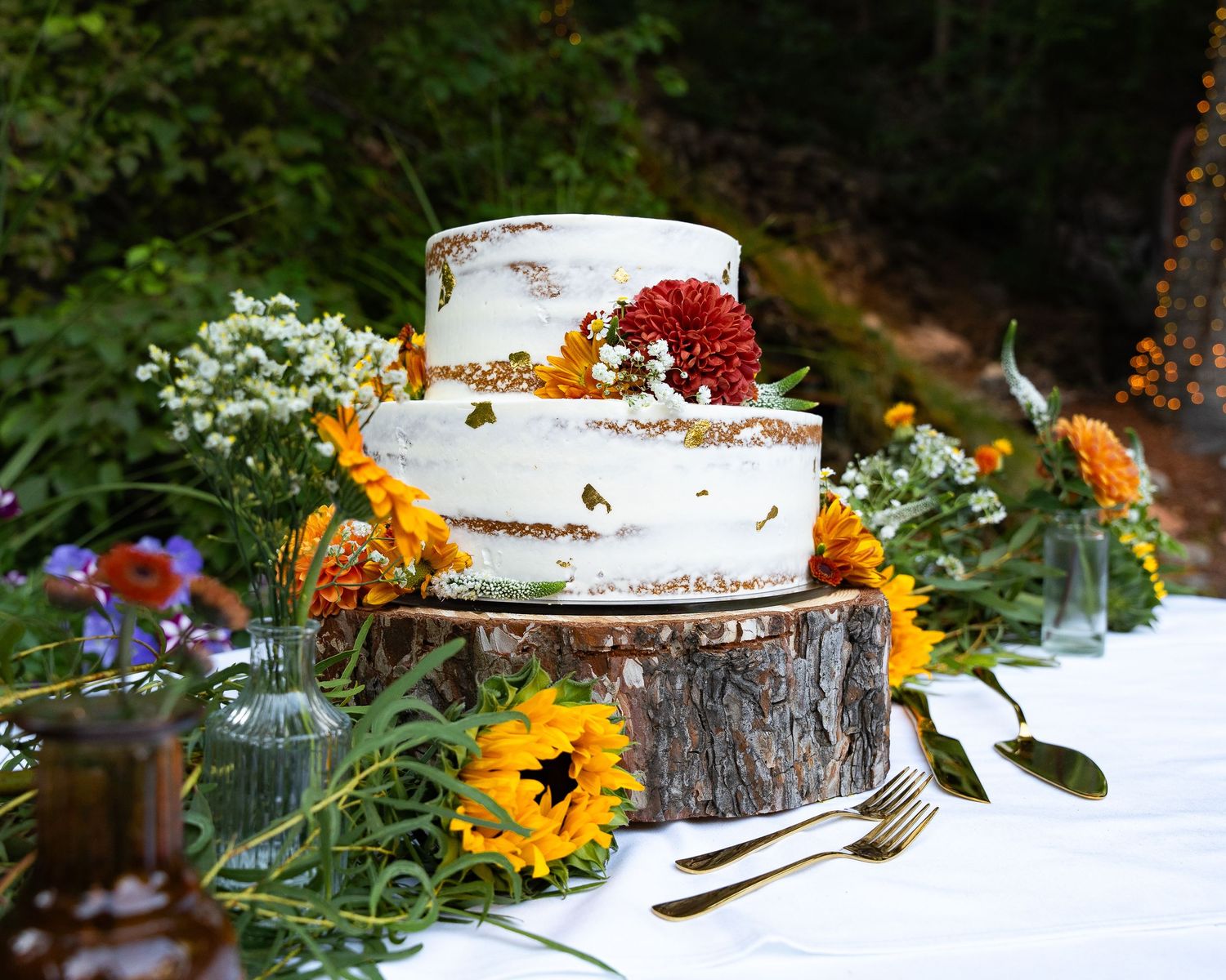 Vibrant Wedding cake sitting with colorful florals in Logan, UT venue located in the American west heritage center.