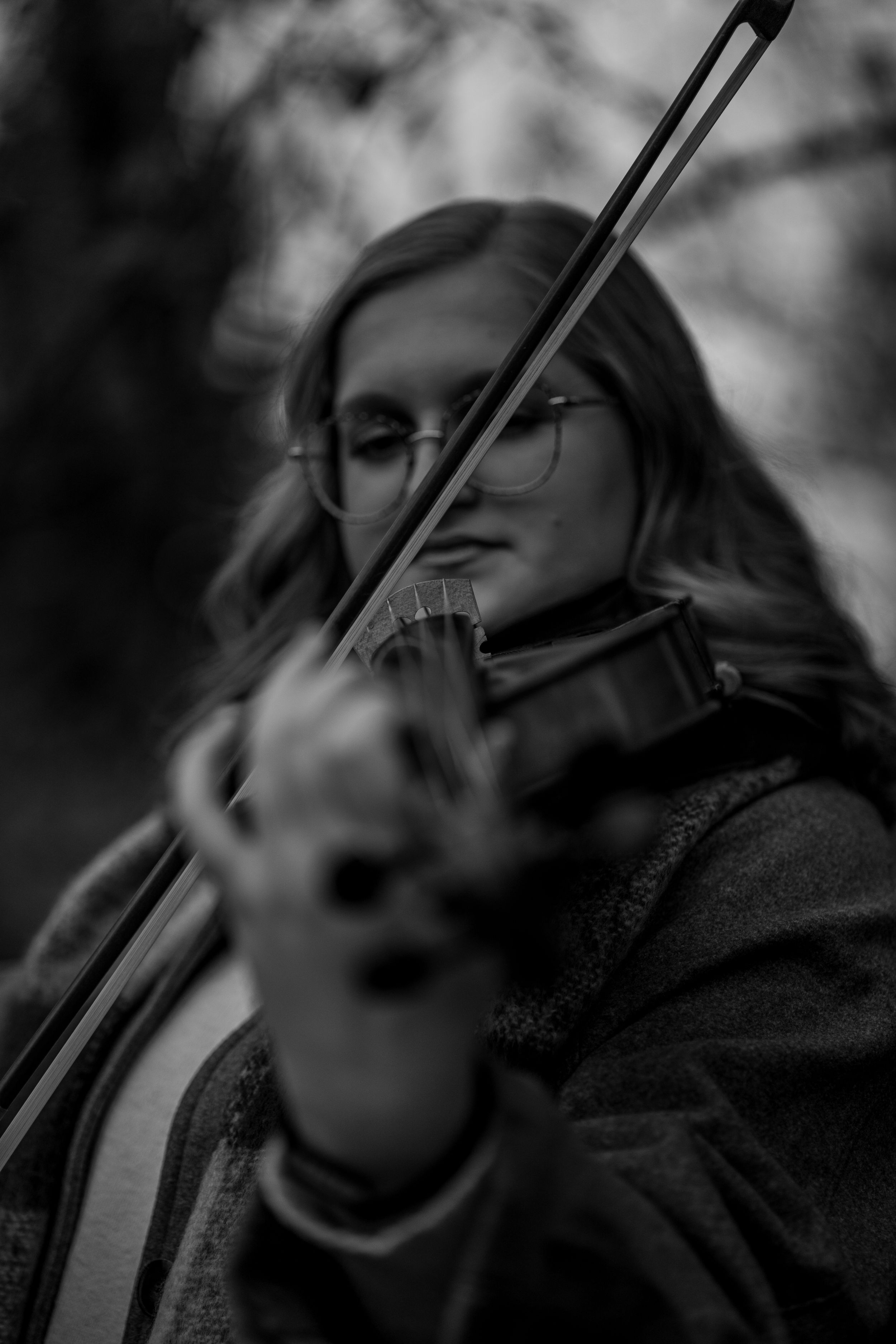 Black and white portrait sequence of a violin player performing with dramatic lighting and expressive movements.