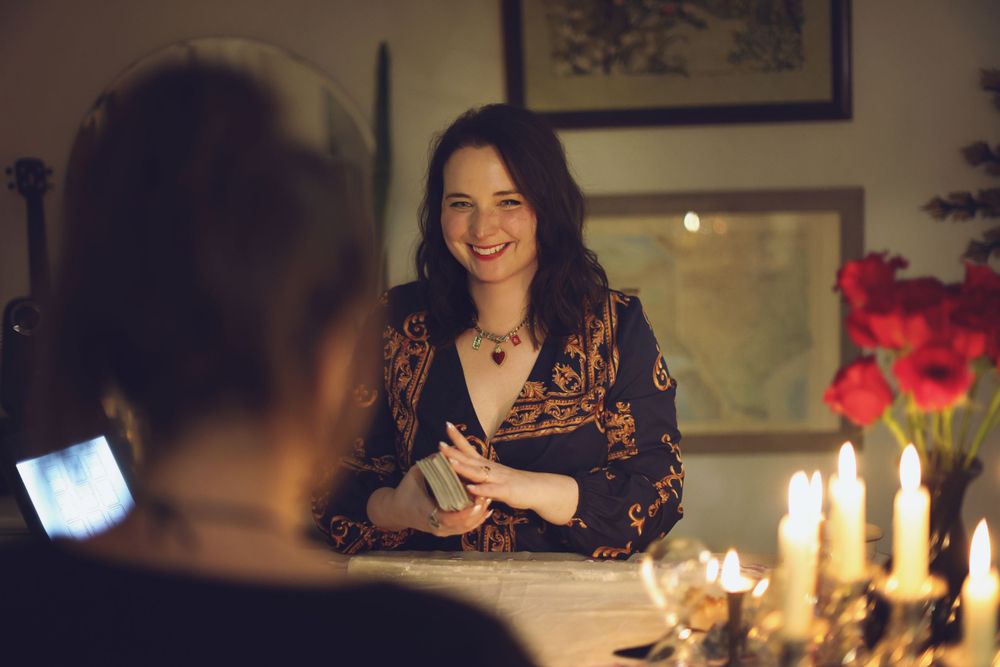 Candlelit table setting with person at romantic dinner.