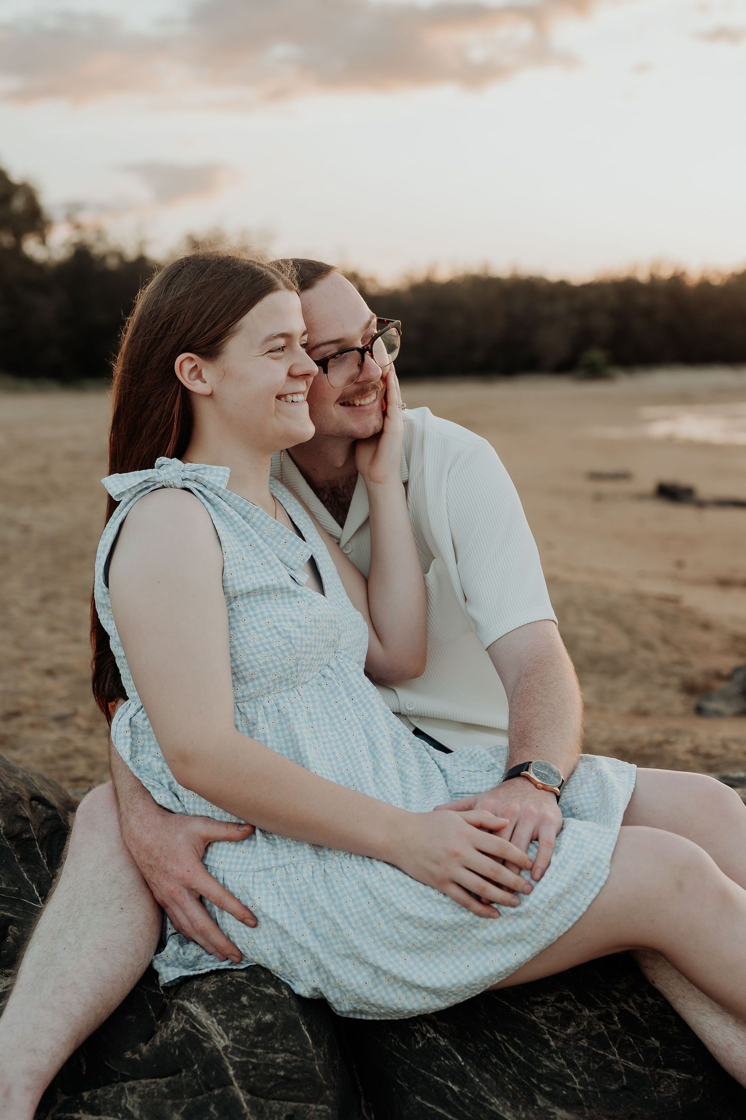 Couple sharing intimate moments during golden hour at tannum sands beach.
