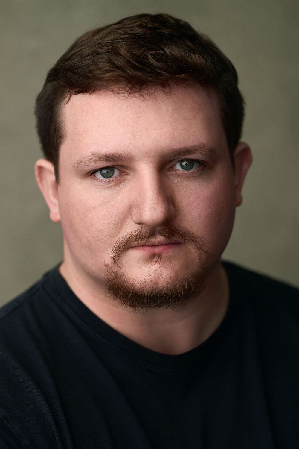 Headshot of actor Oscar Mackie shot in the London studio