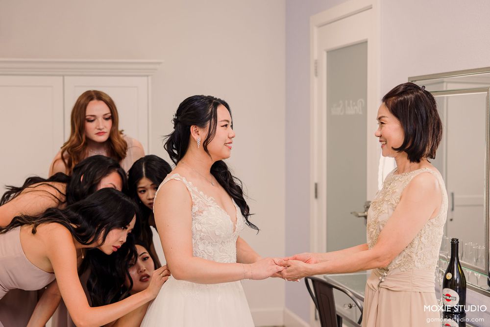 Emotional sequence of wedding party members embracing and sharing joyful moments in a white room.