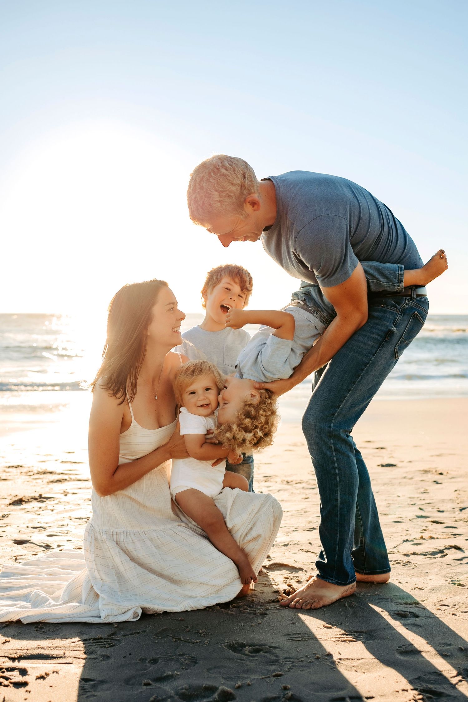 A heartwarming family moment captured during sunset at the beach.