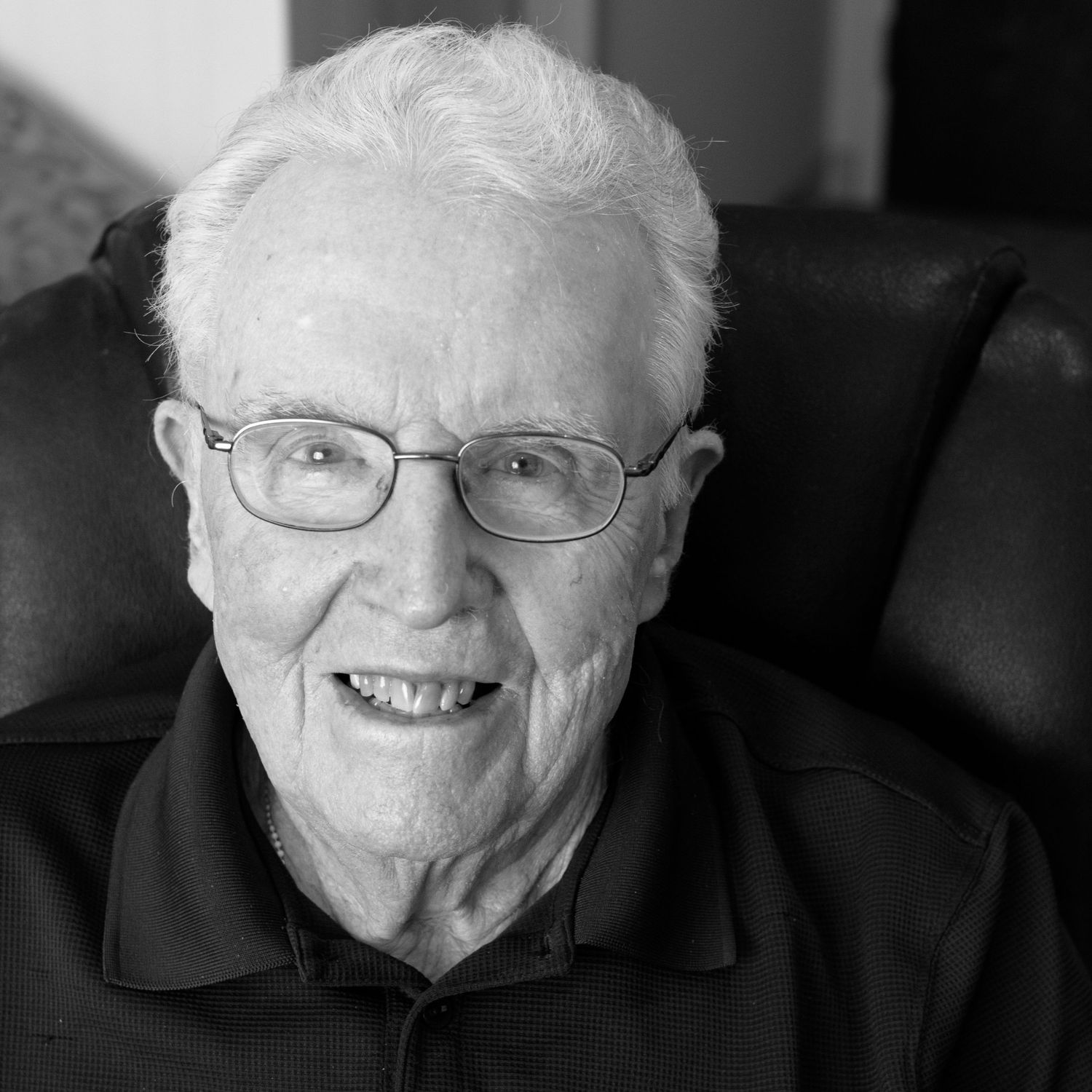 an elderly man smiles at camera