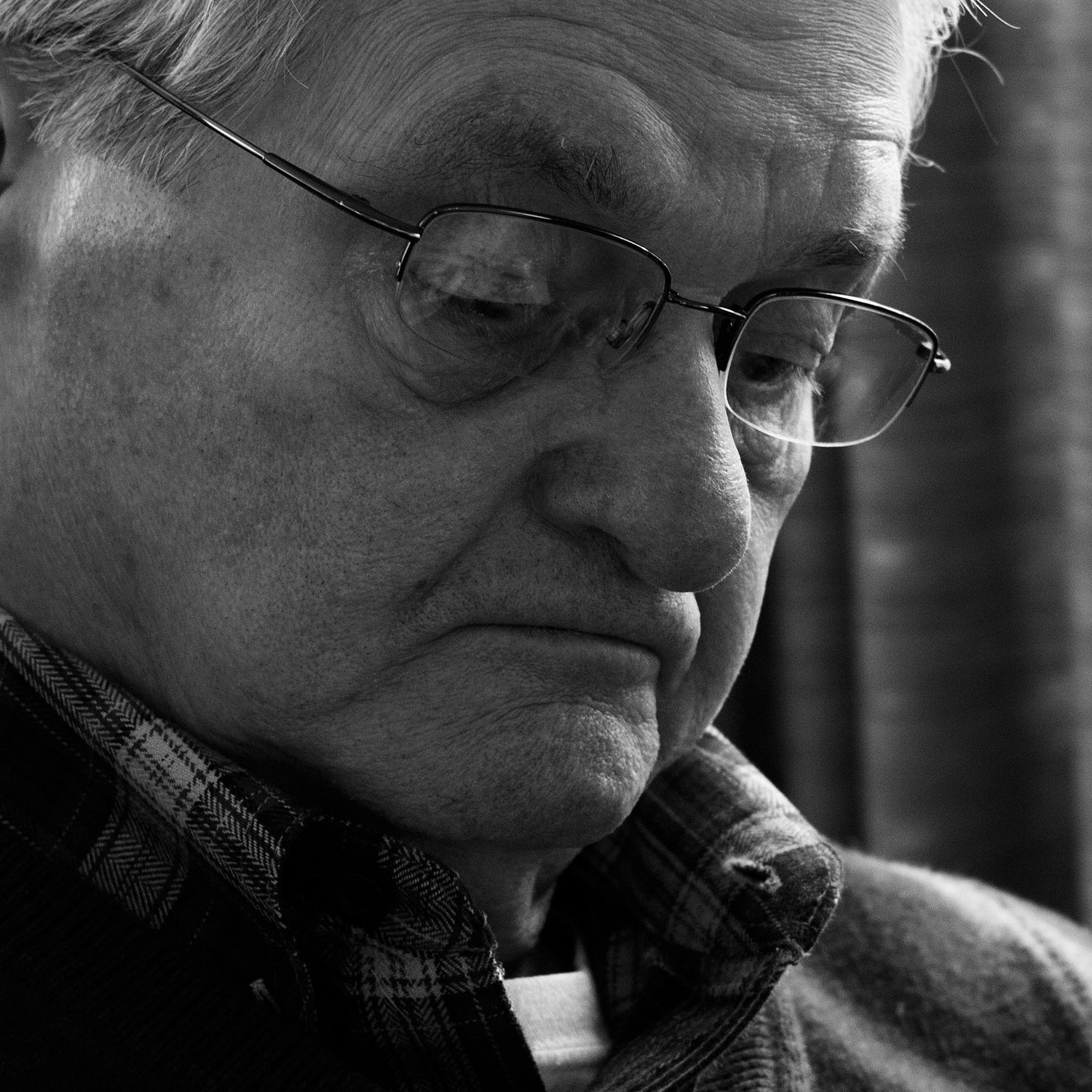 older man looks down, deep in thought