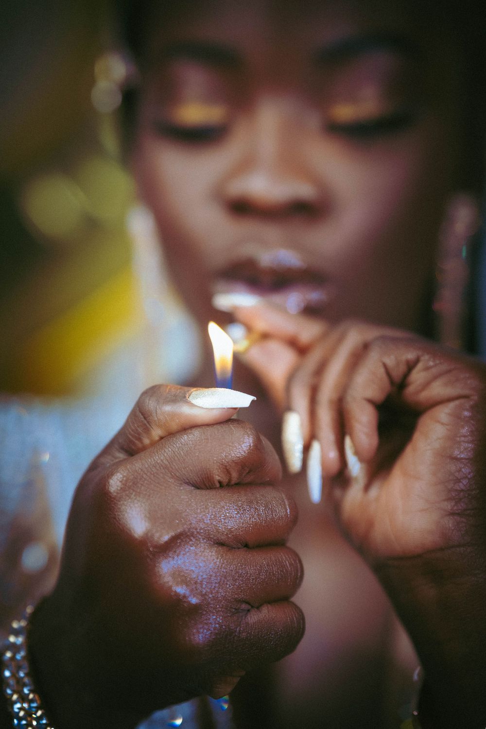 Artistic close-up shot showing detailed nail art and jewelry.
