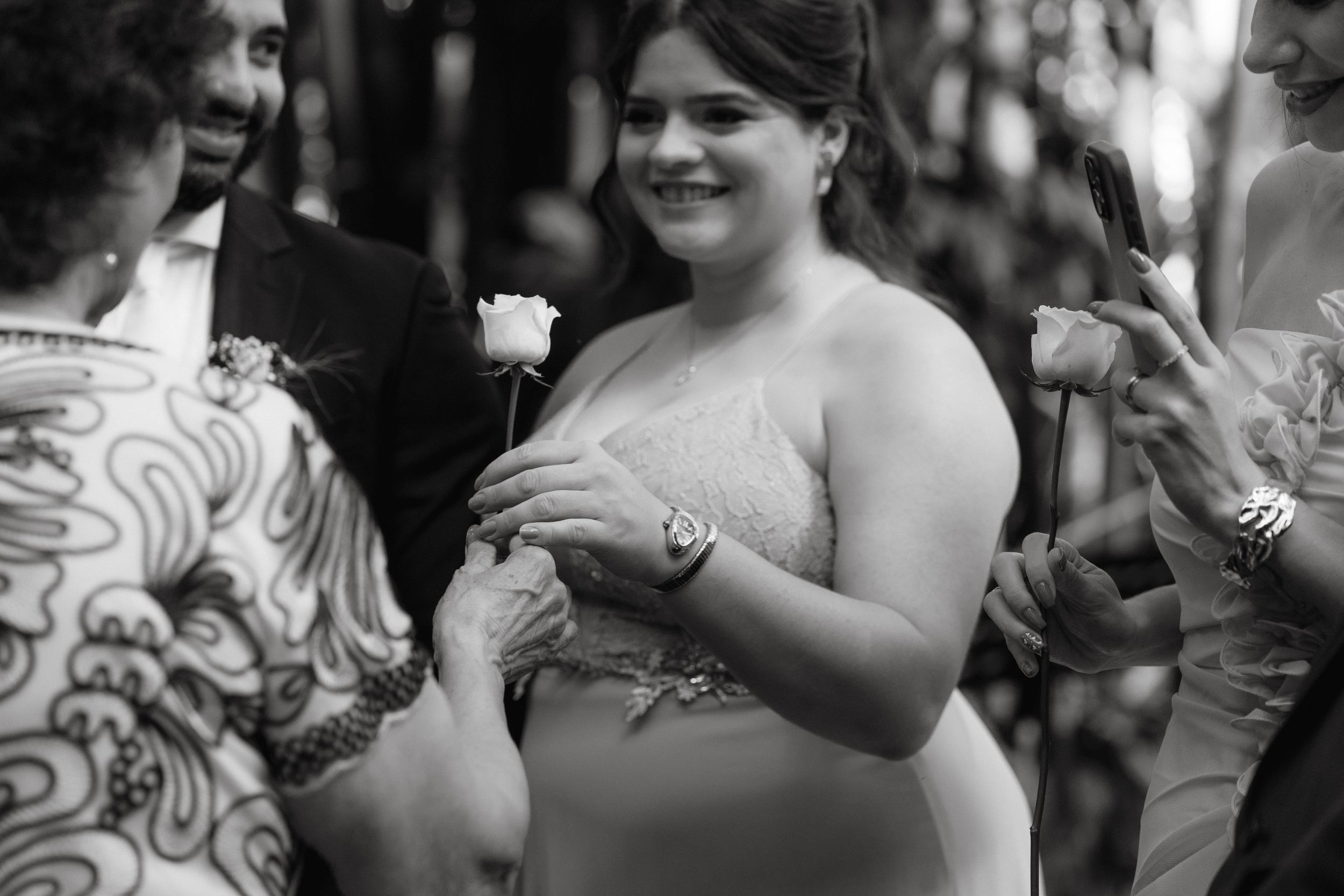 Black and white candid moments from a wedding celebration.