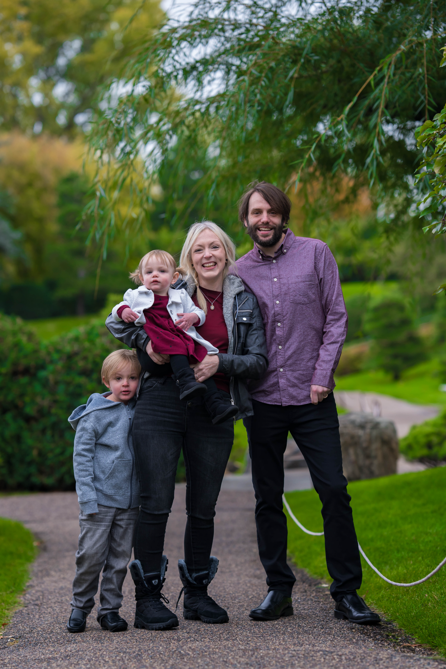 A family gathers together, smiling for a photo, capturing their love and bond