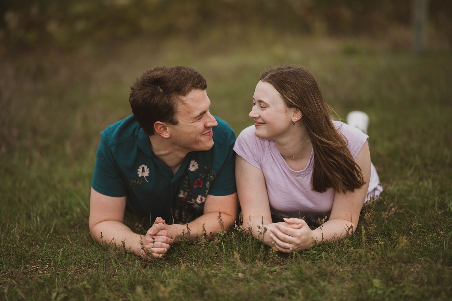 A loving embrace between the couple, their happiness evident in their smiles