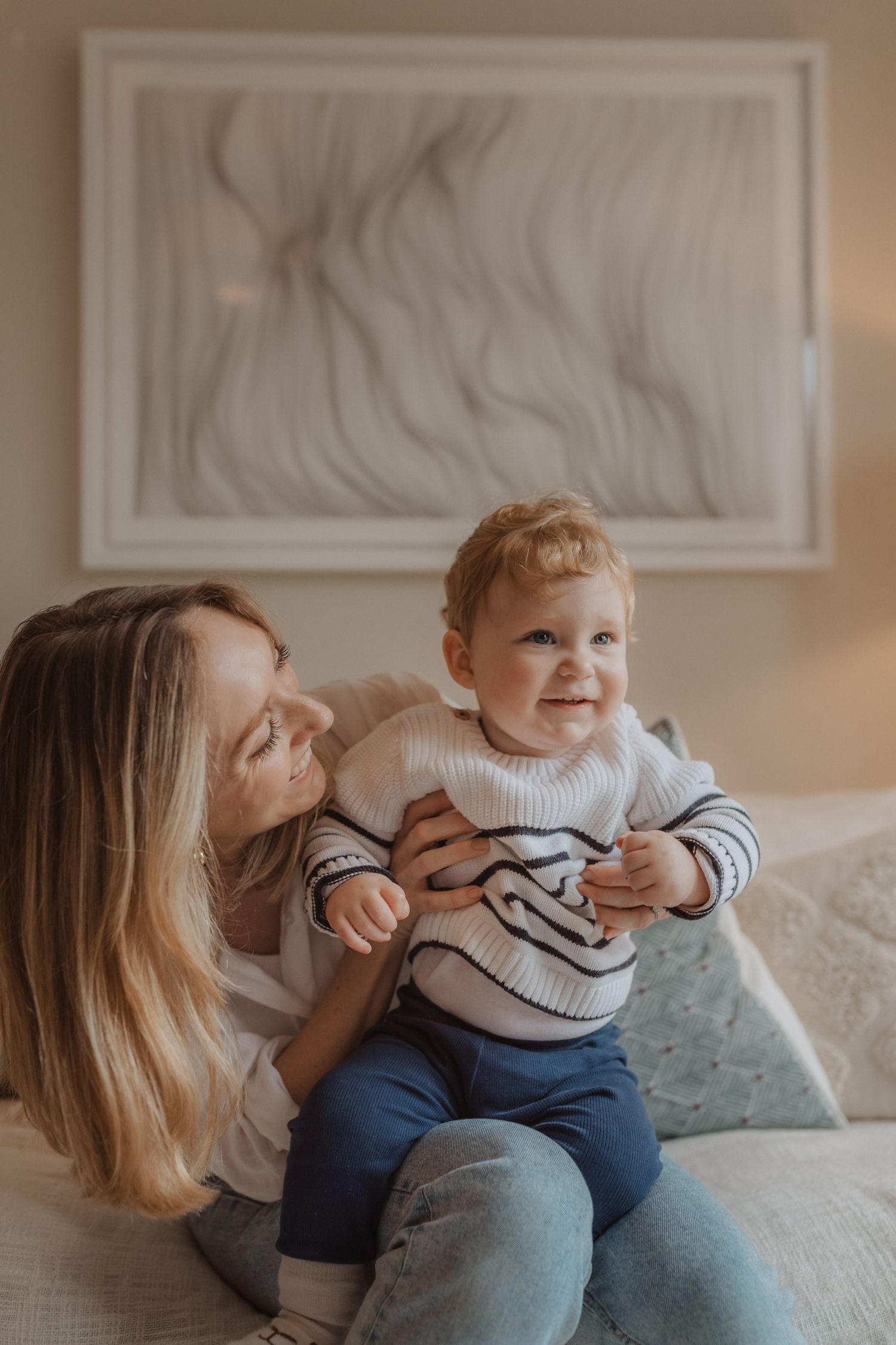 Mother and baby sharing playful moments on a couch in a series of candid photos.