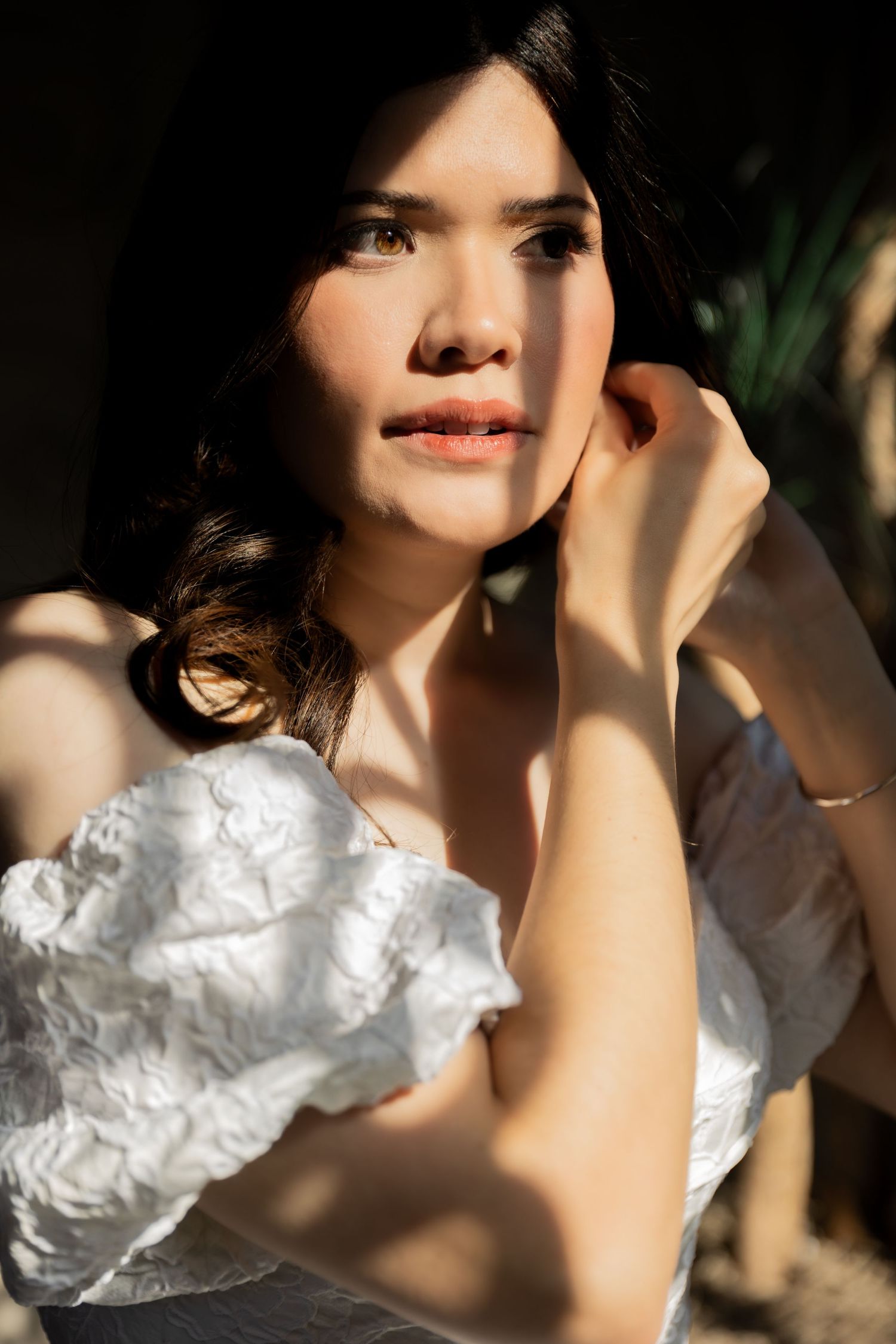 Dramatic Bridal portrait in natural lighting with white lace details.