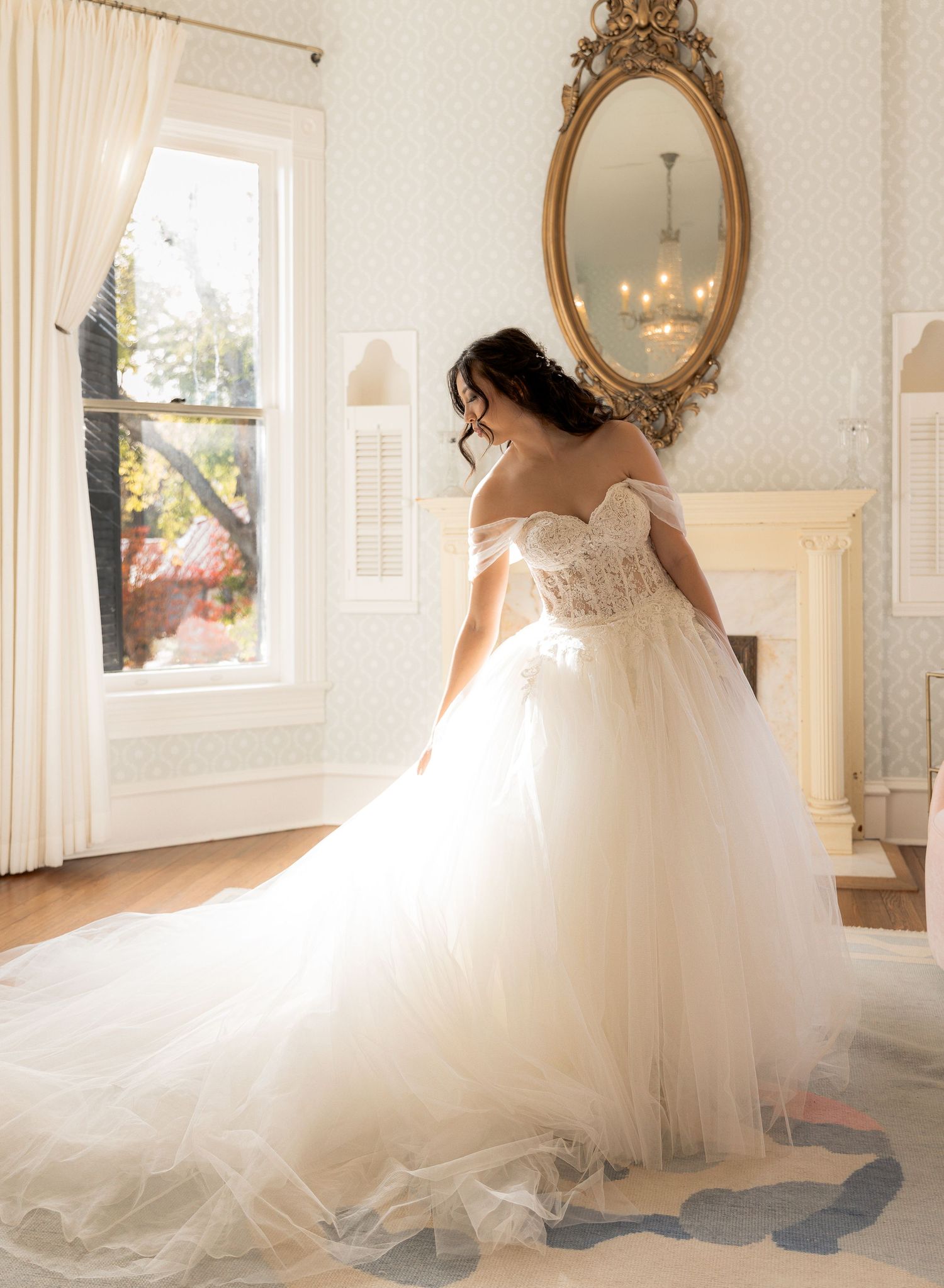 A princess ball gown wedding dress with sweetheart neckline captured in natural window light.