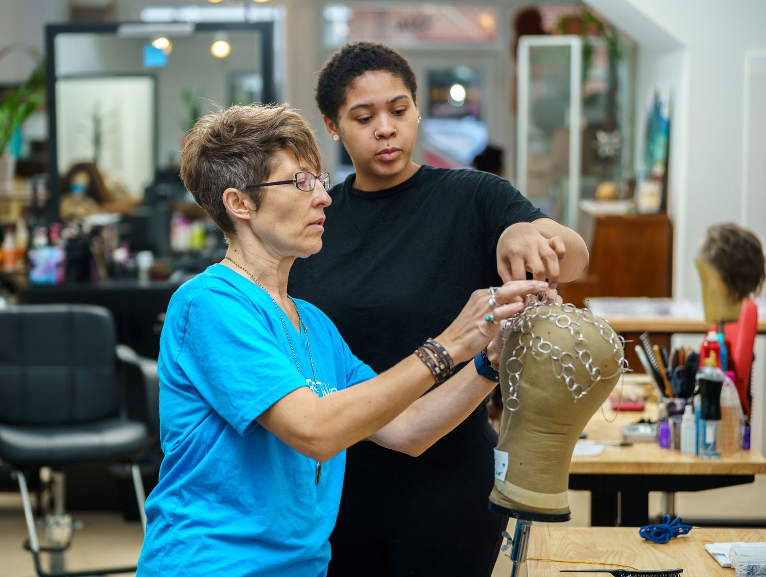 People working together in a salon or beauty training setting.