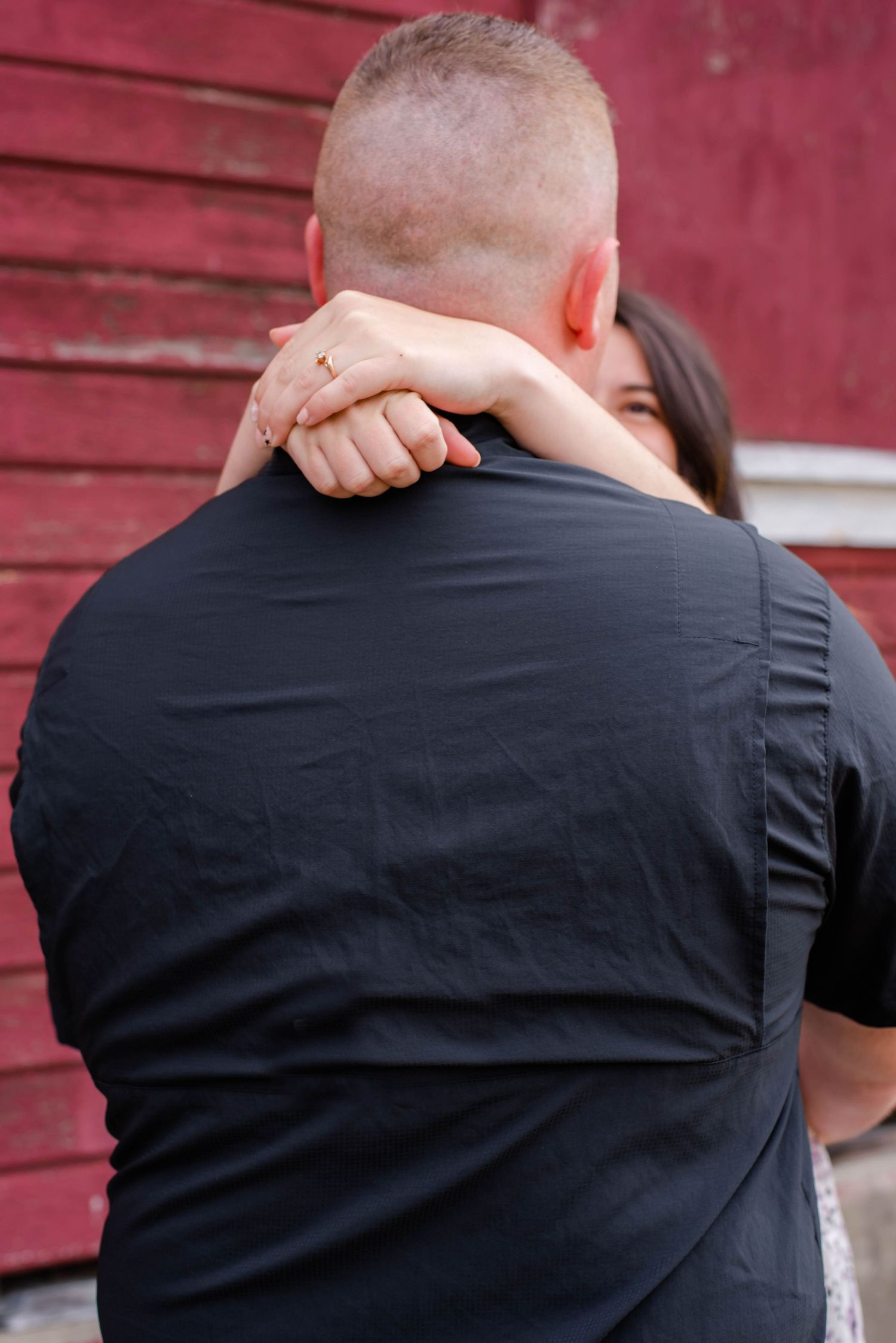 Sequence showing couple engaged in romantic dance moves against rustic red barn wall background.