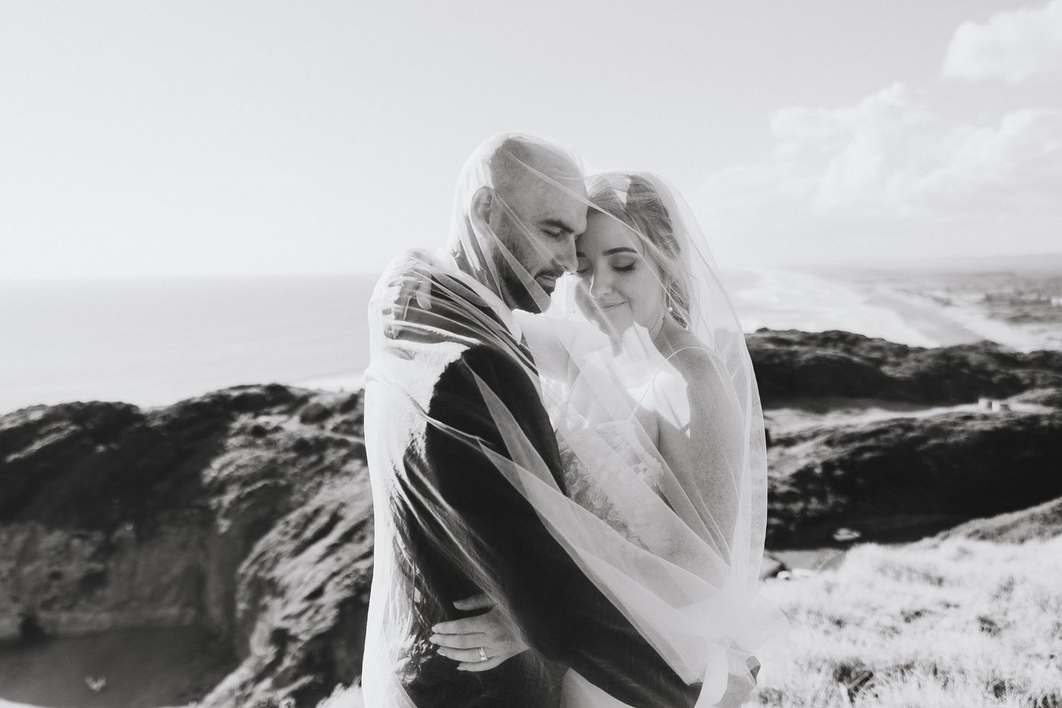 bride and groom under the veil at Muriwai and Ceremony at Tui Hill Swanson