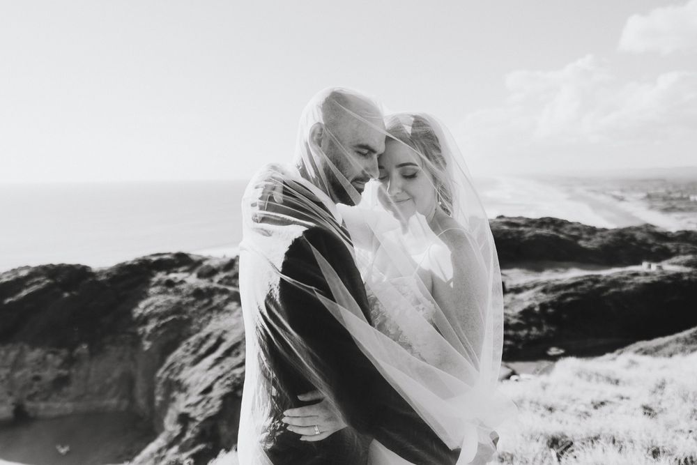 bride and groom under the veil at Muriwai and Ceremony at Tui Hill Swanson