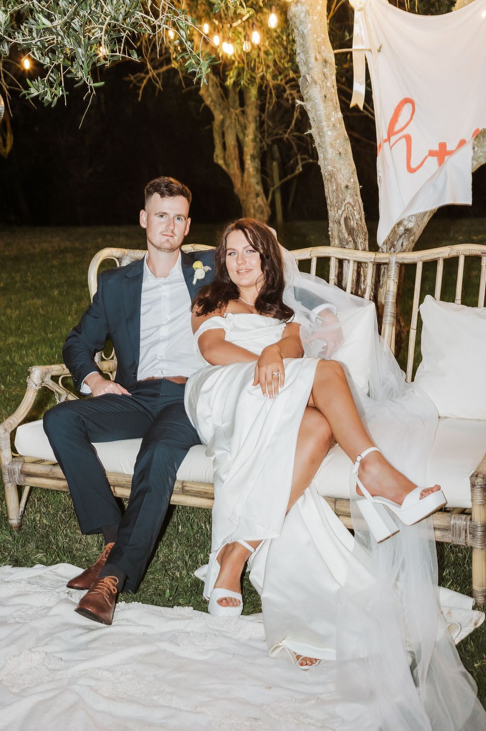 Bride and groom sitting during reception at their wedding Kati Kati. Tauranga Photographer
