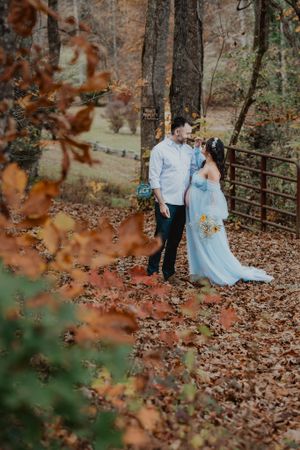 Intimate couple photos in a wooded autumn setting with rustic fence.