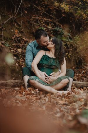 Intimate couple's portrait session among autumn leaves showing tender moments and embraces.