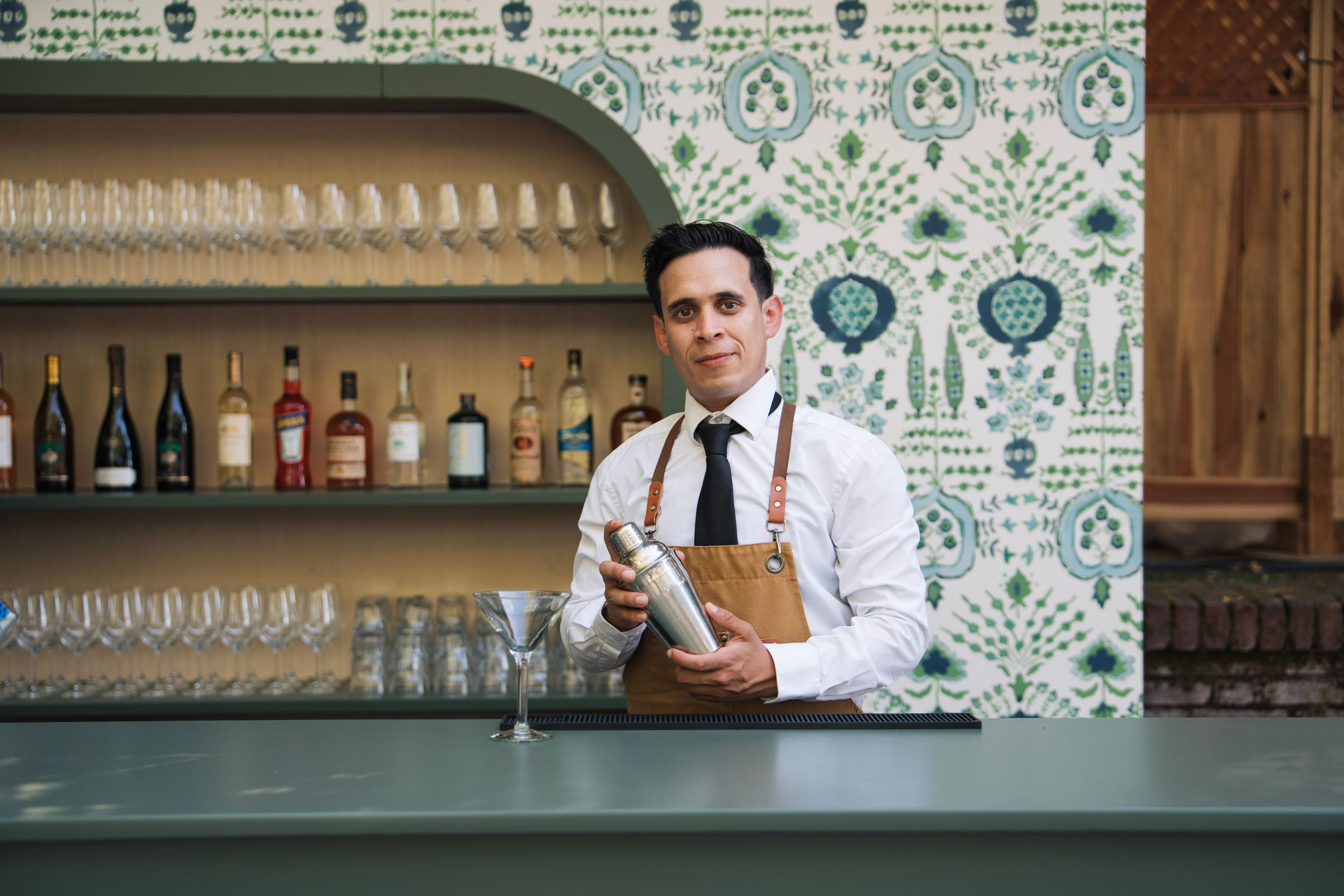 A man creates a margarita behind the bar for bar branding photos