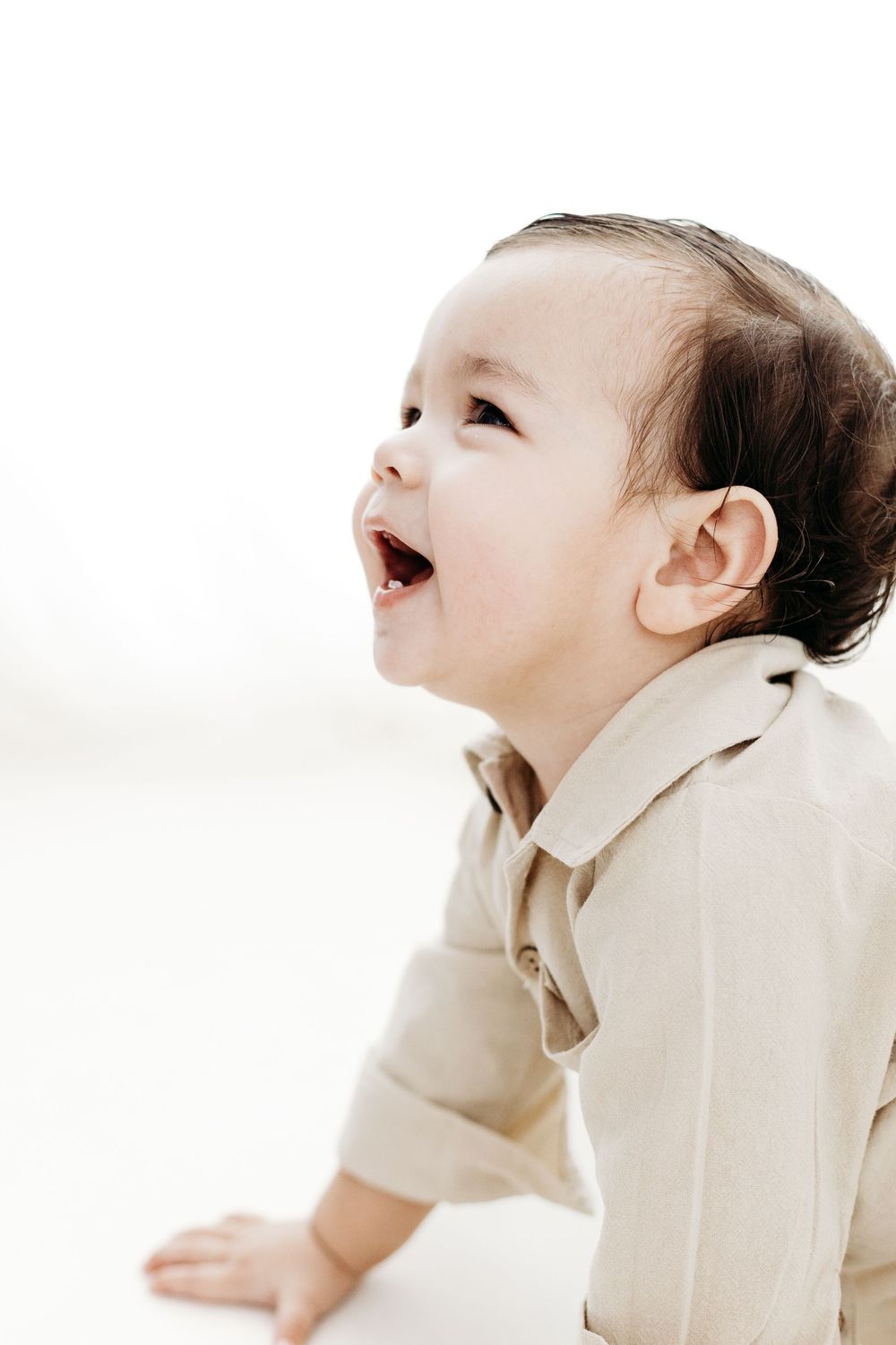 Professional toddler portrait with soft neutral styling.