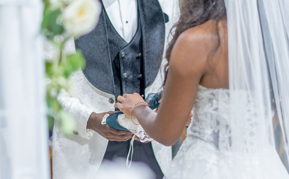 Artistic black and white shot of bride and groom during intimate wedding ceremony moment.