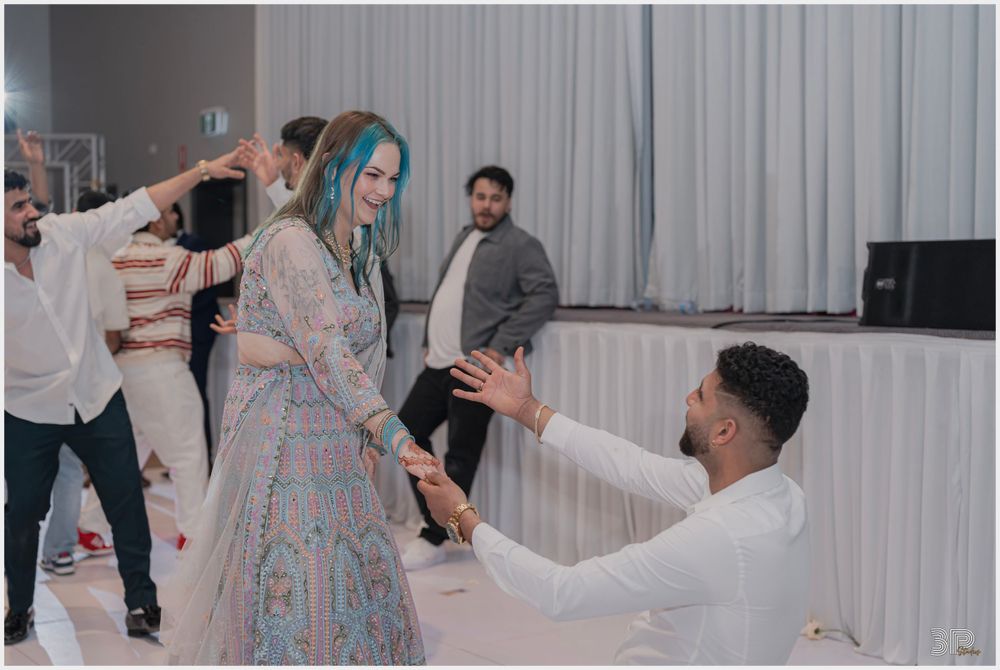 Wedding reception dancing scene with guests in formal attire on dance floor.