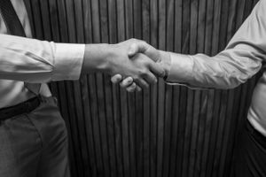 Black and white image of business handshake symbolizing professional agreement.
