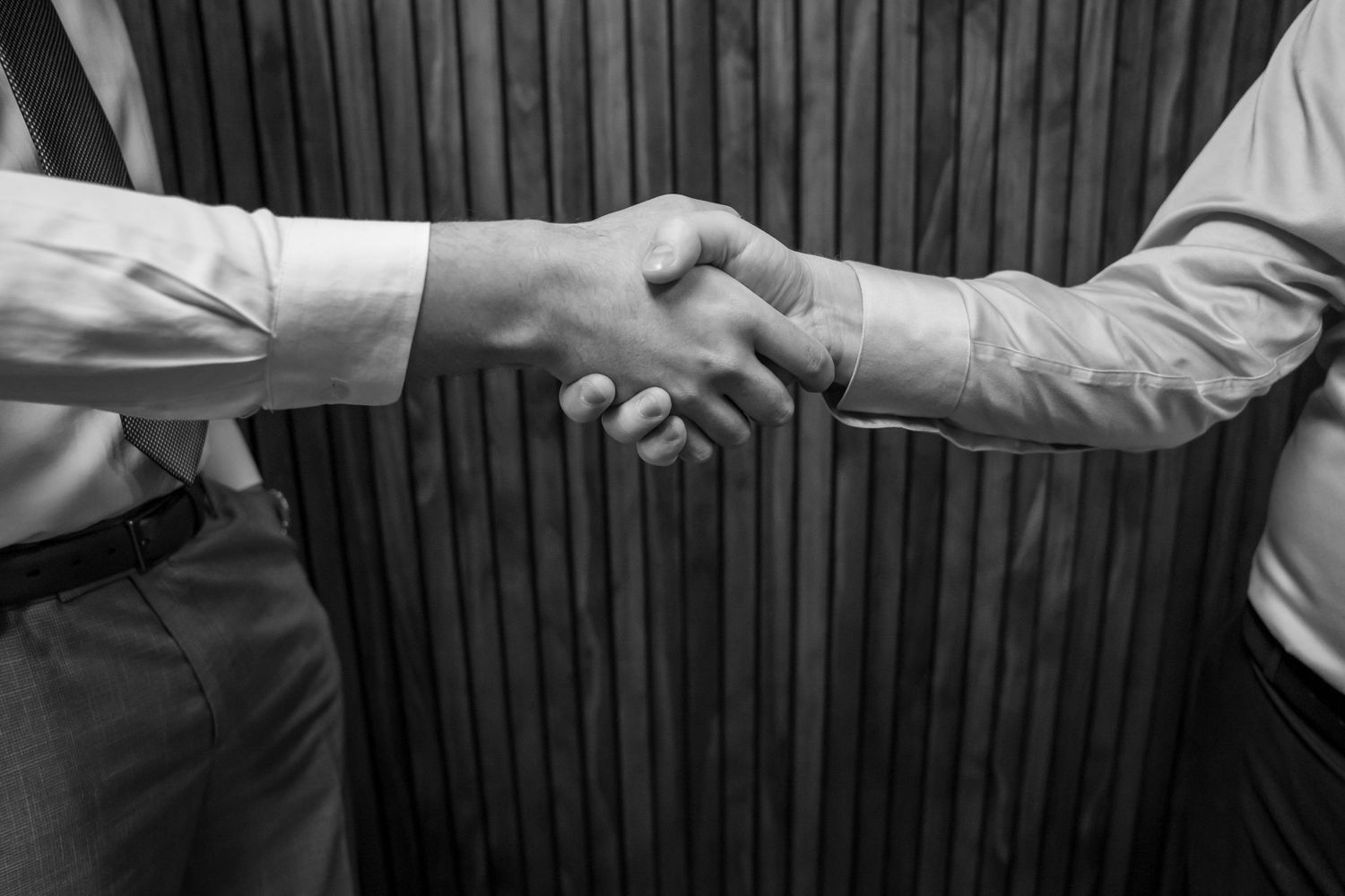 Black and white image of business handshake symbolizing professional agreement.