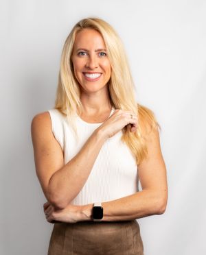 Business casual portraits combining a white ribbed top with earth tones against a neutral backdrop.