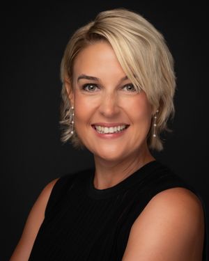 Professional studio portraits of a woman in black against dark background showing different expressions and poses.