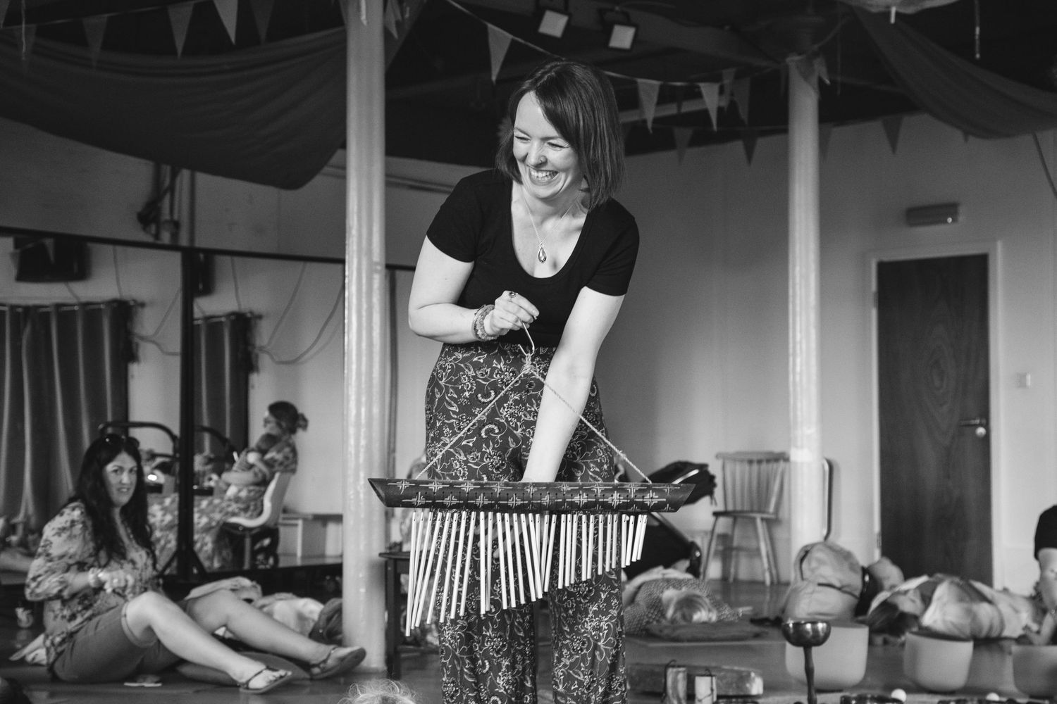 A performer playing a xylophone instrument during an indoor performance.