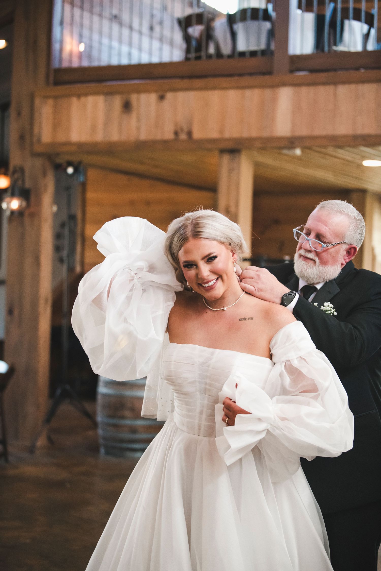 A joyful moment captured during a wedding reception in a rustic wooden venue.