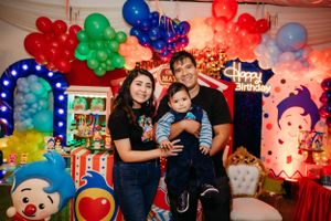 Colorful birthday celebration with balloon arrangements and circus-themed decorations.